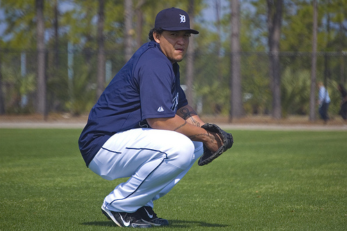 Miguel Cabrera squatting on a practice field